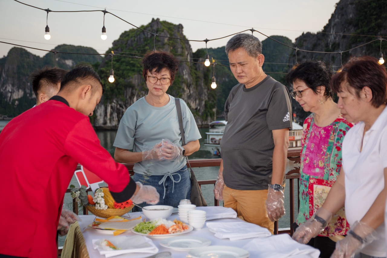 Fresh seafood cooking class with tourists at Halong Bay, Vietnam - authentic culinary experience.