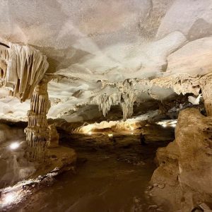 Stunning limestone cave with stalactites and stalagmites in a scenic underground tour.