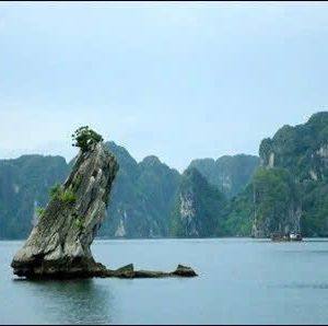 Limestone karst island in Ha Long Bay, Vietnam with scenic water views.