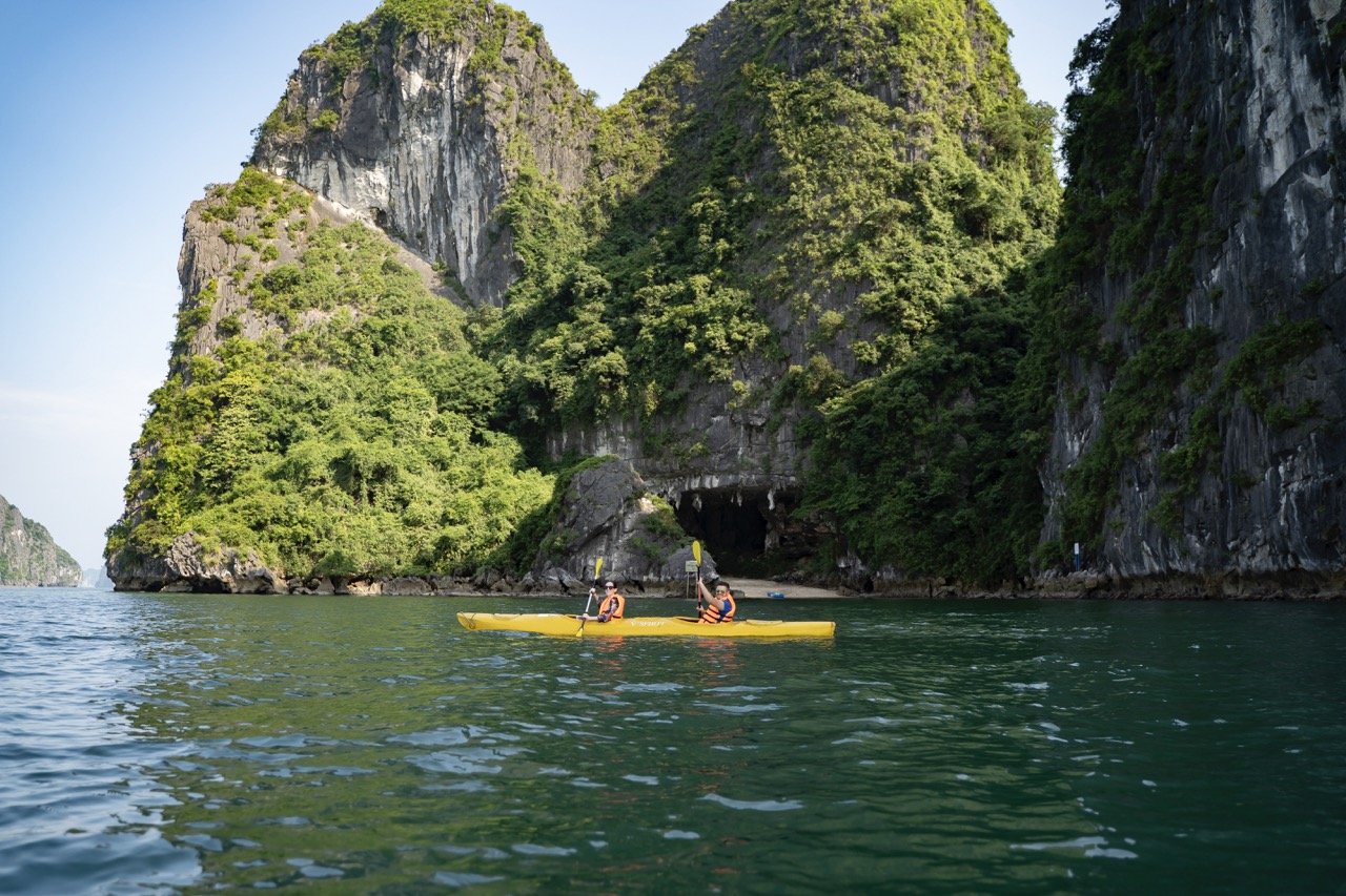 Lush green limestone islands with kayak adventure in Ha Long Bay, Vietnam.