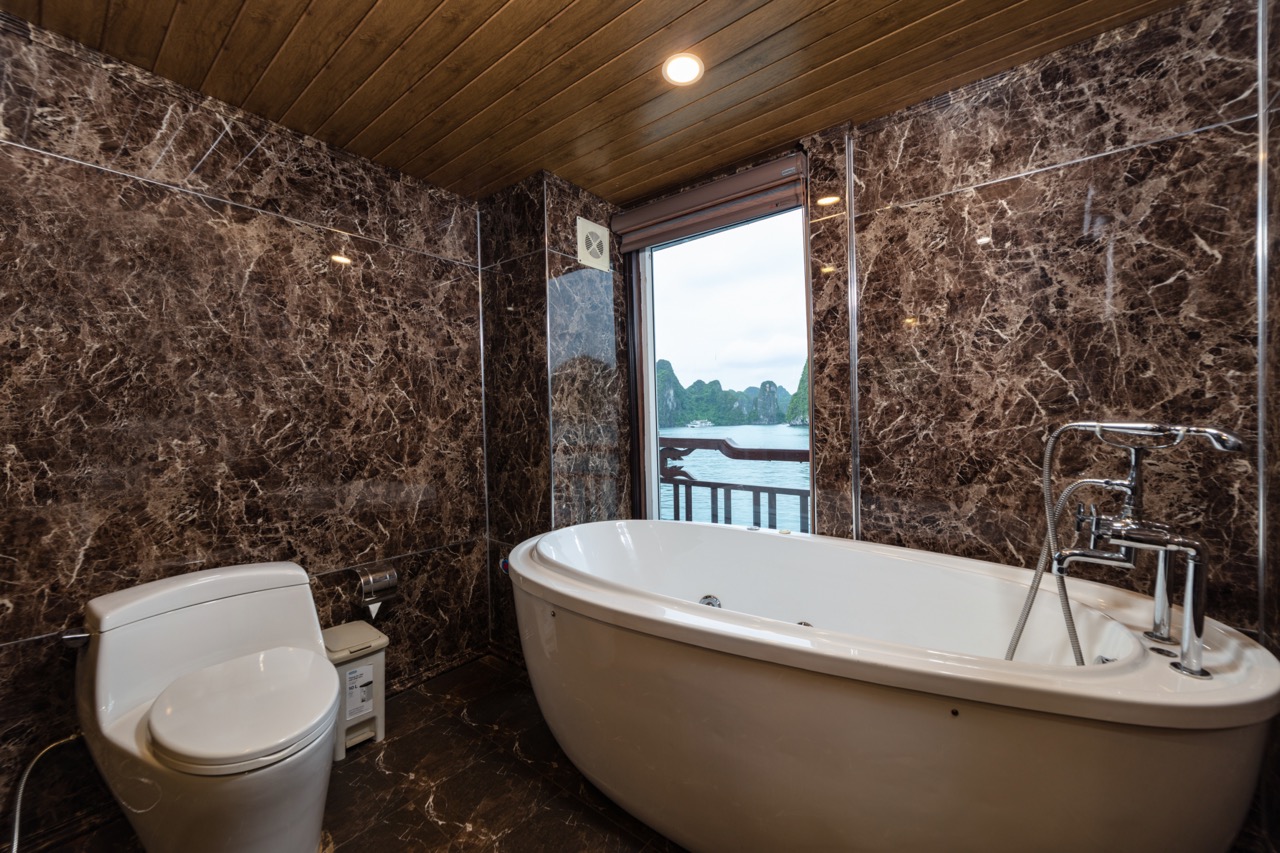 Luxurious bathtub with river view and marble walls, perfect for relaxing in Vietnam.