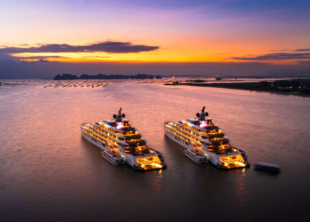 Luxury yachts at sunset in Ha Long Bay, Vietnam, scenic cruise, tropical vacation, boat tour.