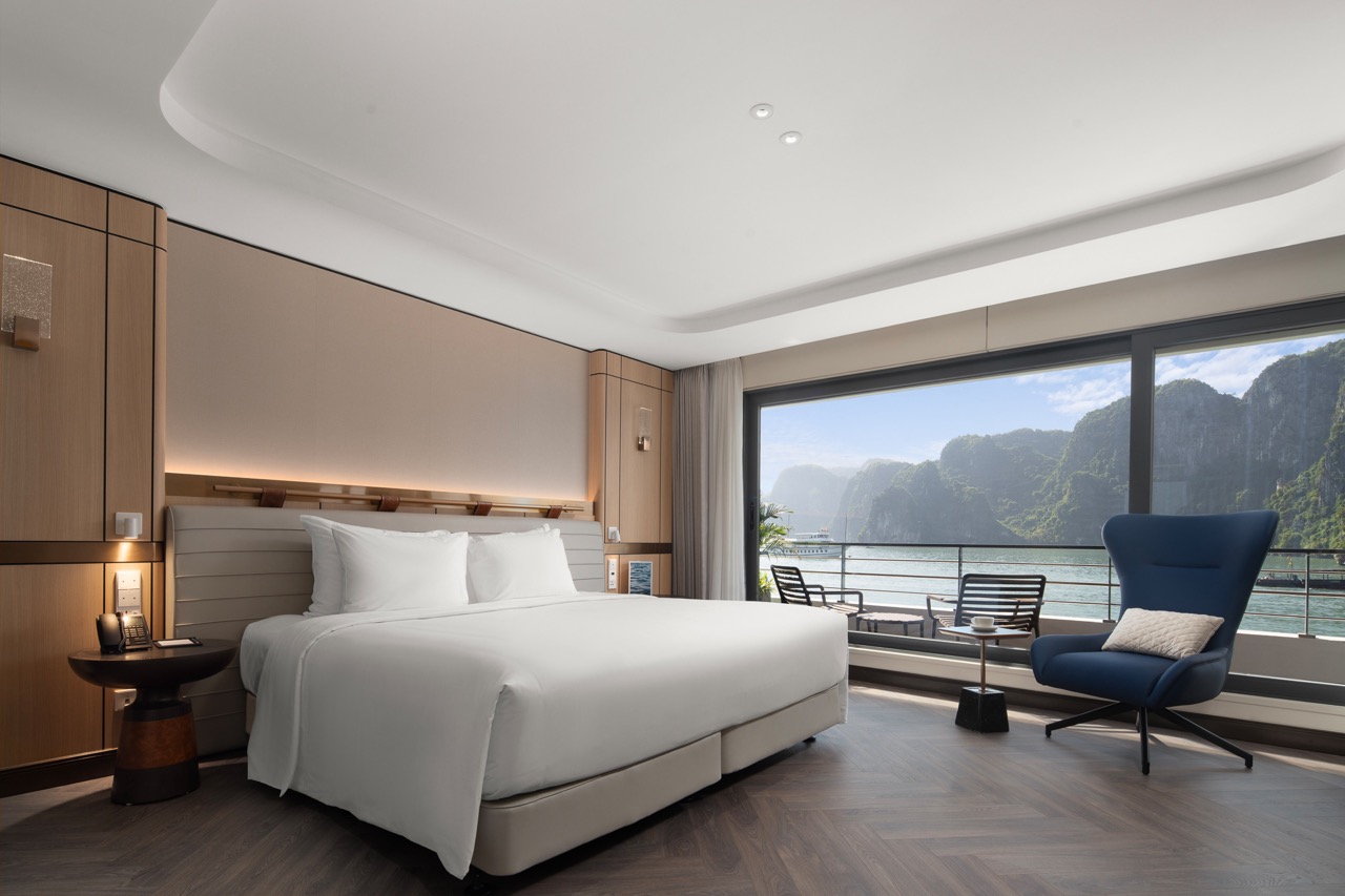 Luxurious hotel room with river view and modern decor.