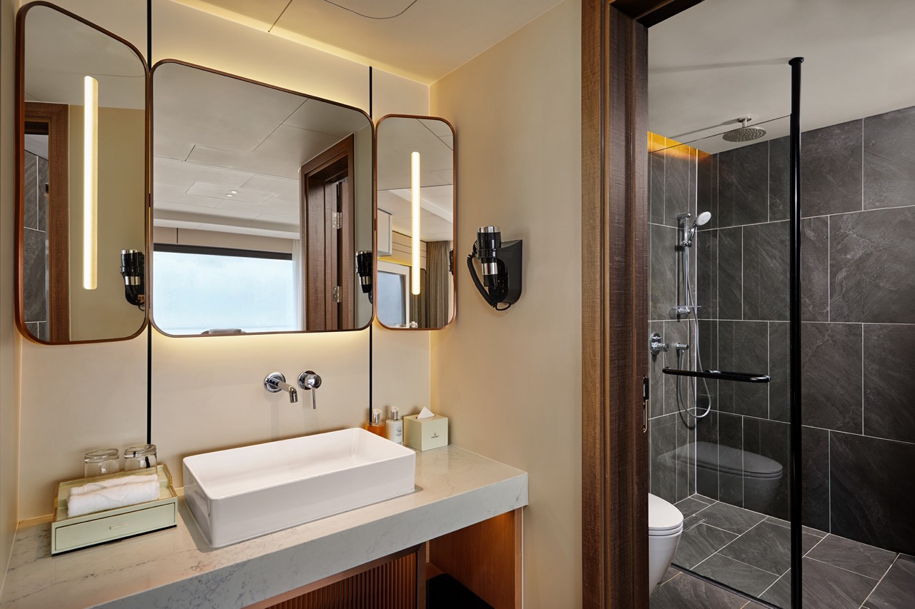Luxurious modern hotel bathroom with walk-in shower, elegant design, and premium amenities.