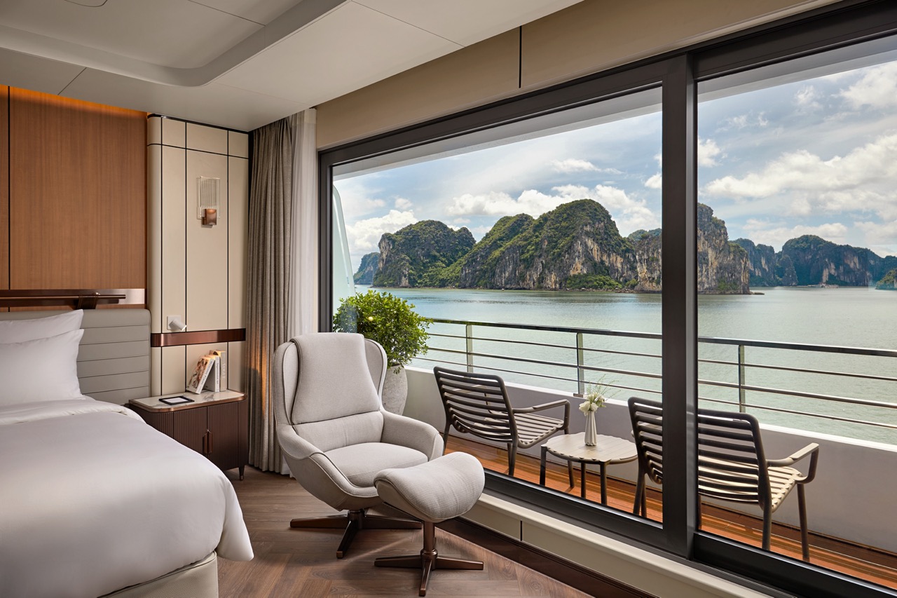 Breathtaking bay view from a luxurious hotel room overlooking limestone islands and calm waters.