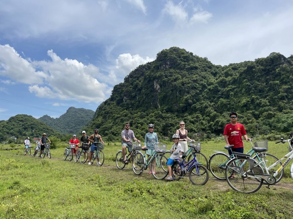 Enjoying scenic cycling tours in Vietnam's lush green mountains and countryside with ViettrendTour.