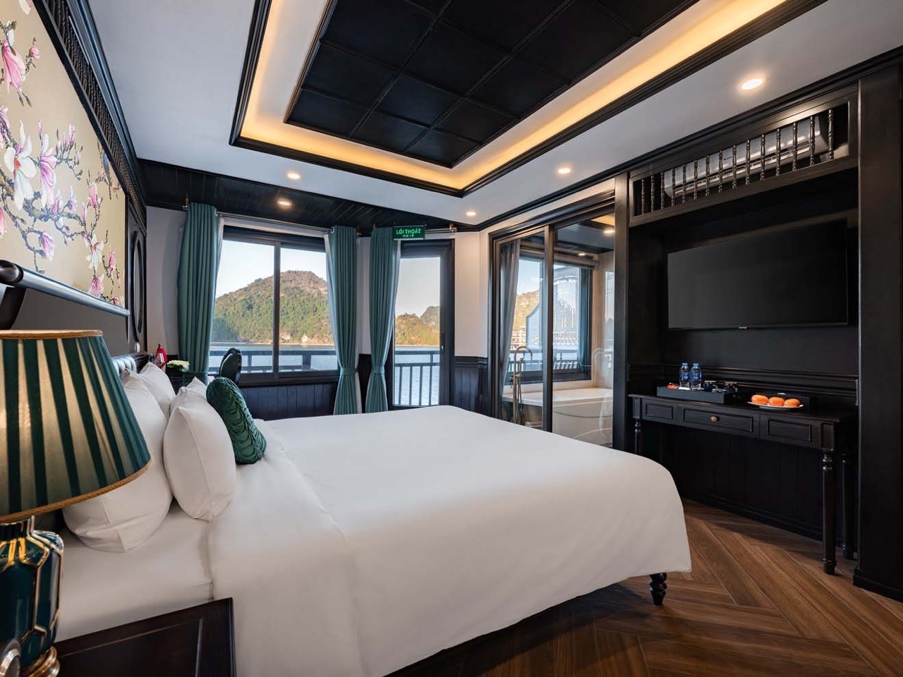 Scenic Halong Bay cruise balcony with luxurious interior, perfect for a memorable 2D1N experience.