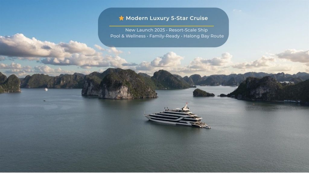 Elegant cruise sailing through Halong Bay's stunning limestone karsts and emerald waters, offering a.
