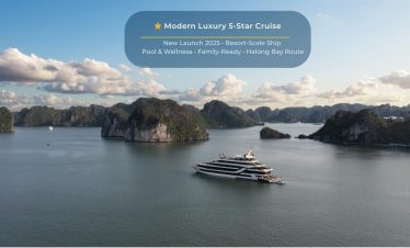Elegant cruise sailing through Halong Bay's stunning limestone karsts and emerald waters, offering a.