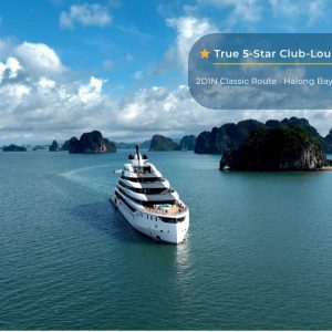 Luxury yacht cruising in Halong Bay with limestone islands, part of Vietnam's iconic UNESCO World Heritage site.