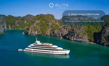 Stunning view of a modern cruise ship sailing through emerald waters surrounded by towering limeston.