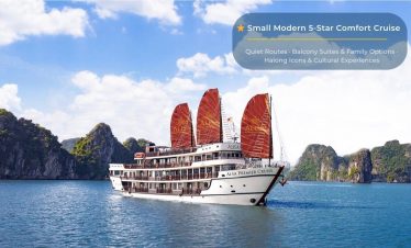 Elegant cruise ship sailing through stunning Halong Bay with towering limestone karsts and emerald w.