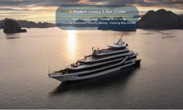 Elegant cruise ship sailing through Halong Bay's stunning limestone karsts at sunset.