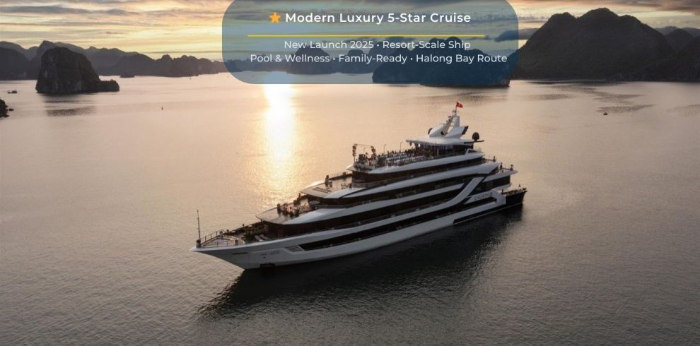 Elegant cruise ship sailing through Halong Bay's stunning limestone karsts at sunset.