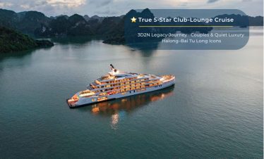 Luxury cruise boat in Halong Bay at sunset, offering 5-star yacht tours and scenic island visits.