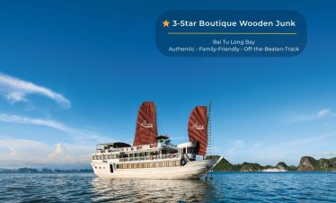 Elegant Bai Tu Long Bay cruise ship with traditional sails, offering luxurious experiences amidst st.