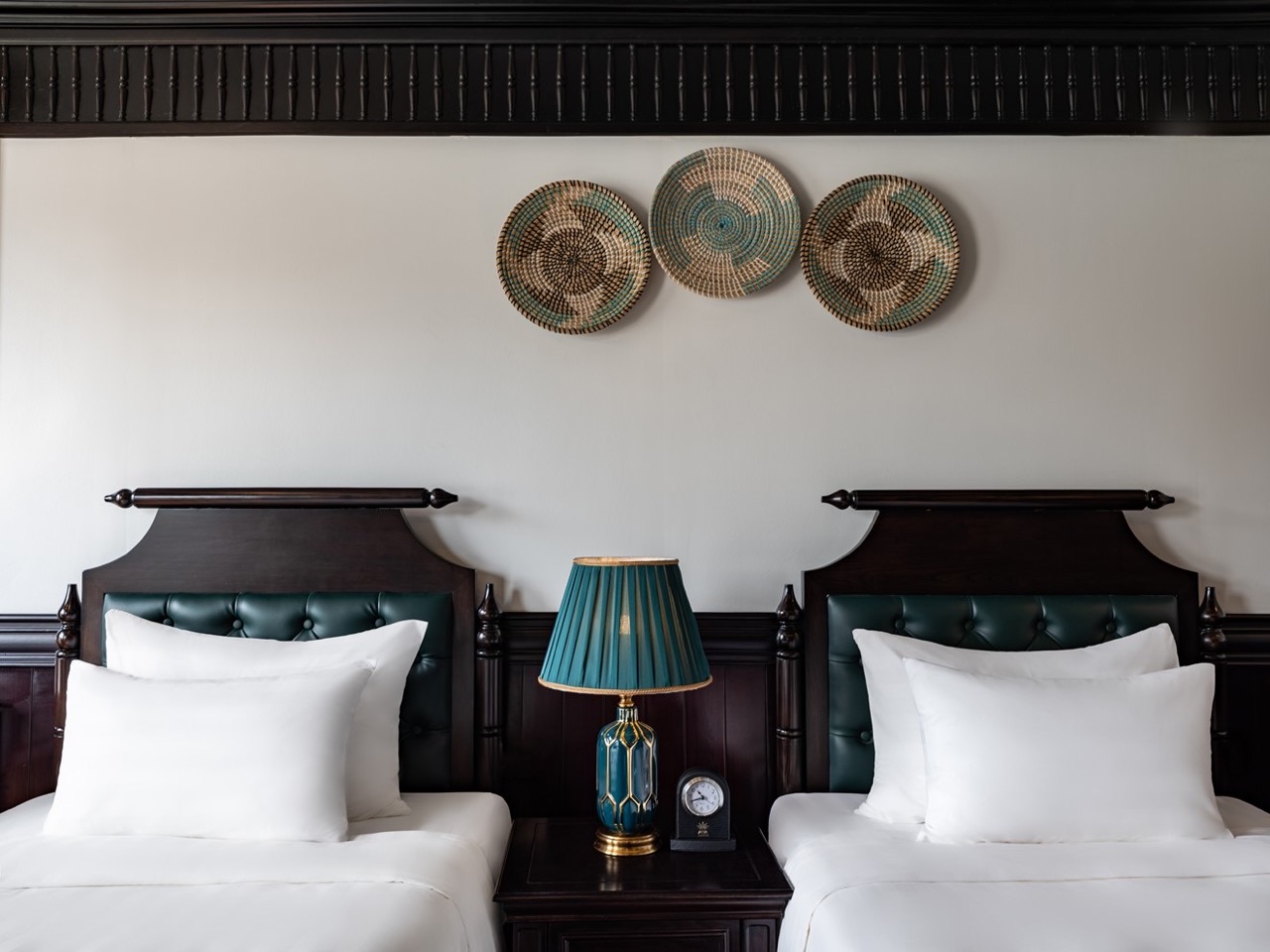 Elegant cruise balcony view of Halong Bay with twin beds and scenic surroundings.