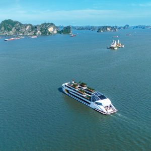 Luxurious cruise sailing in Ha Long Bay with scenic limestone islands.