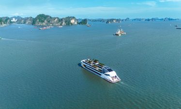 Luxurious cruise sailing in Ha Long Bay with scenic limestone islands.