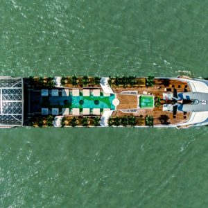 Luxurious yacht cruising in clear waters with a modern deck and hydrophilic amenities.