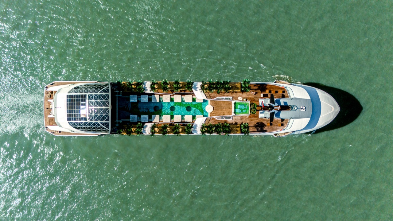 Luxurious yacht cruising in clear waters with a modern deck and hydrophilic amenities.