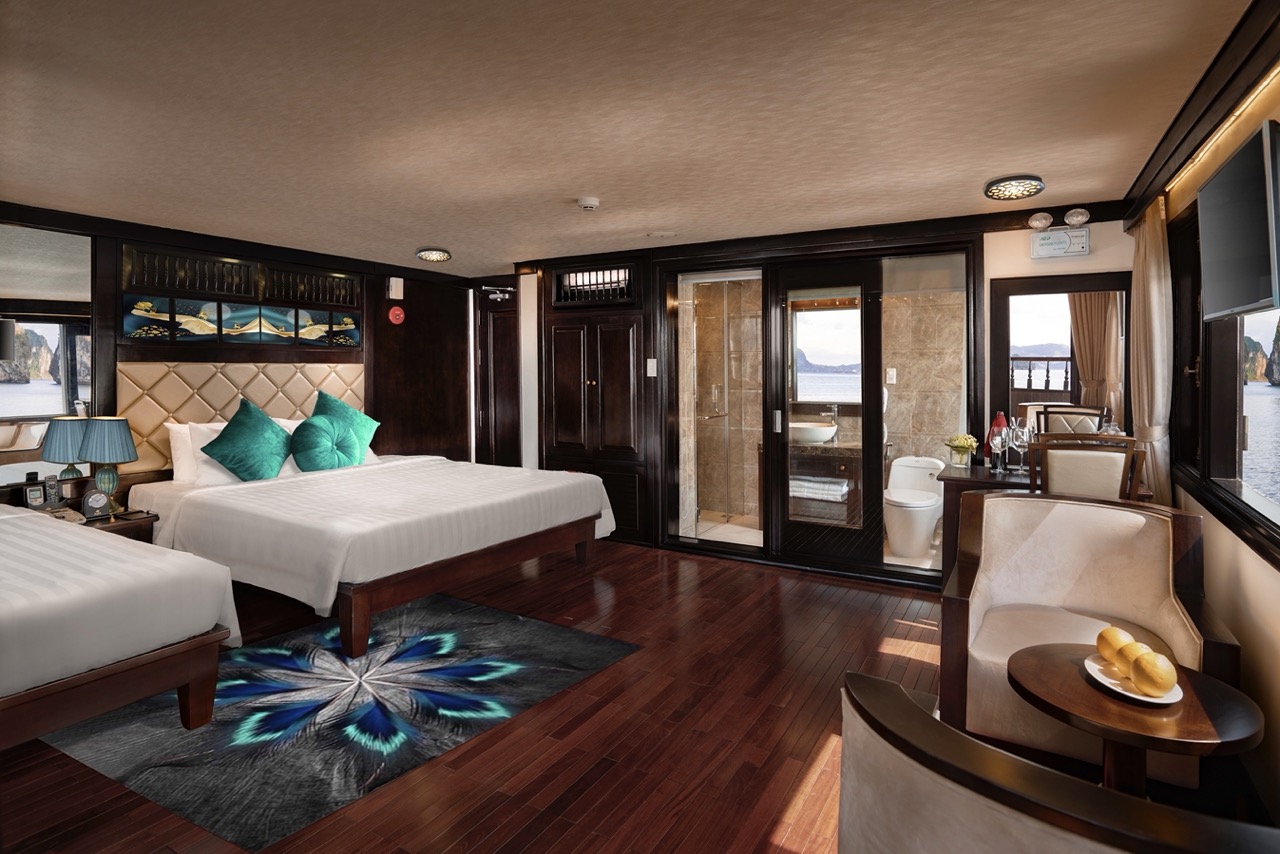 Luxurious cruise cabin with modern decor, large windows, and cozy seating, perfect for relaxing duri.