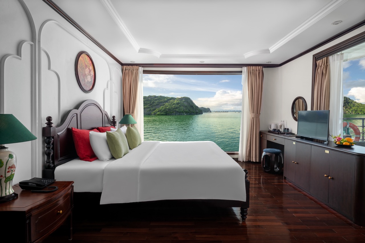Ocean view room on Bai Tu Long Cruise showcasing serene waters and lush islands, perfect for a relax.