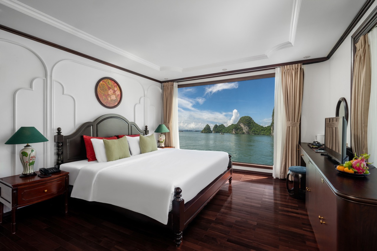 Stunning cruise balcony view of Bai Tu Long Bay with lush islands and clear waters, perfect for a re.