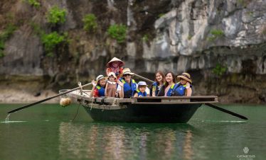 Enjoying a peaceful cruise on Halong Bay with tourists on a boat surrounded by limestone karsts and.