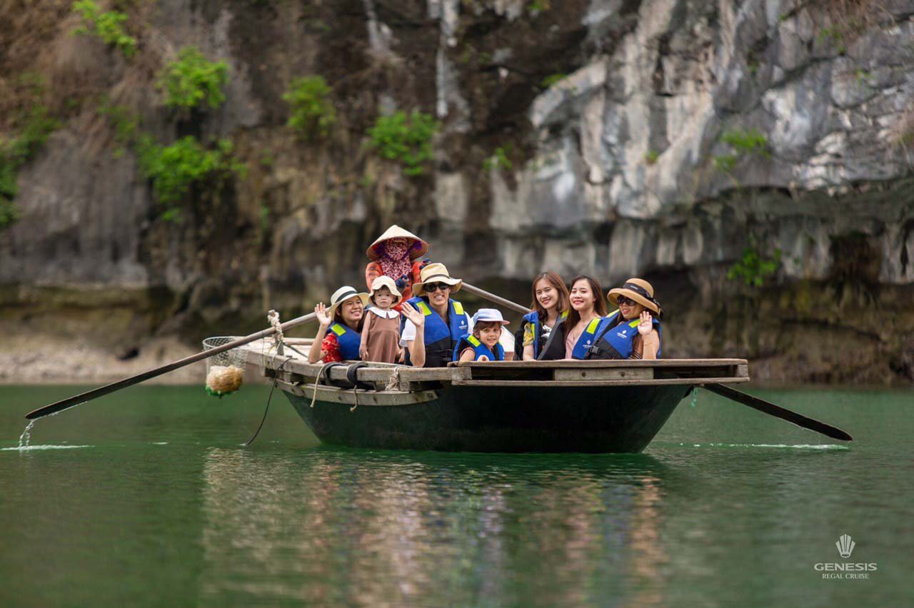Enjoying a peaceful cruise on Halong Bay with tourists on a boat surrounded by limestone karsts and.