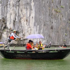 Serene boat tour on Halong Bay with limestone cliffs and emerald waters, perfect for travelers seeking adventure and nature.