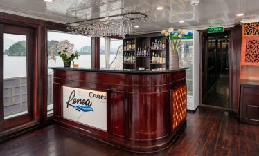 Elegant cruise lounge with bar area overlooking Halong Bay.