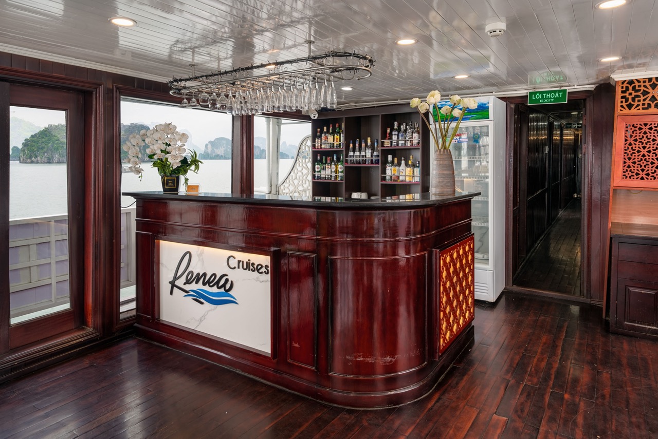 Elegant cruise lounge with bar area overlooking Halong Bay.
