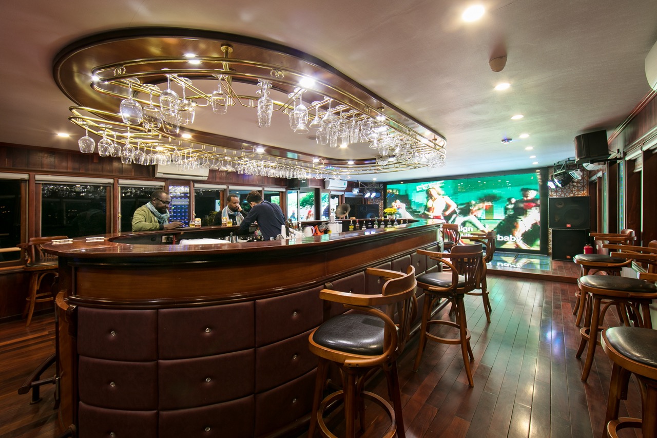 Elegant bar interior with modern lighting and seating, perfect for relaxing after a day of travel in Vietnam.
