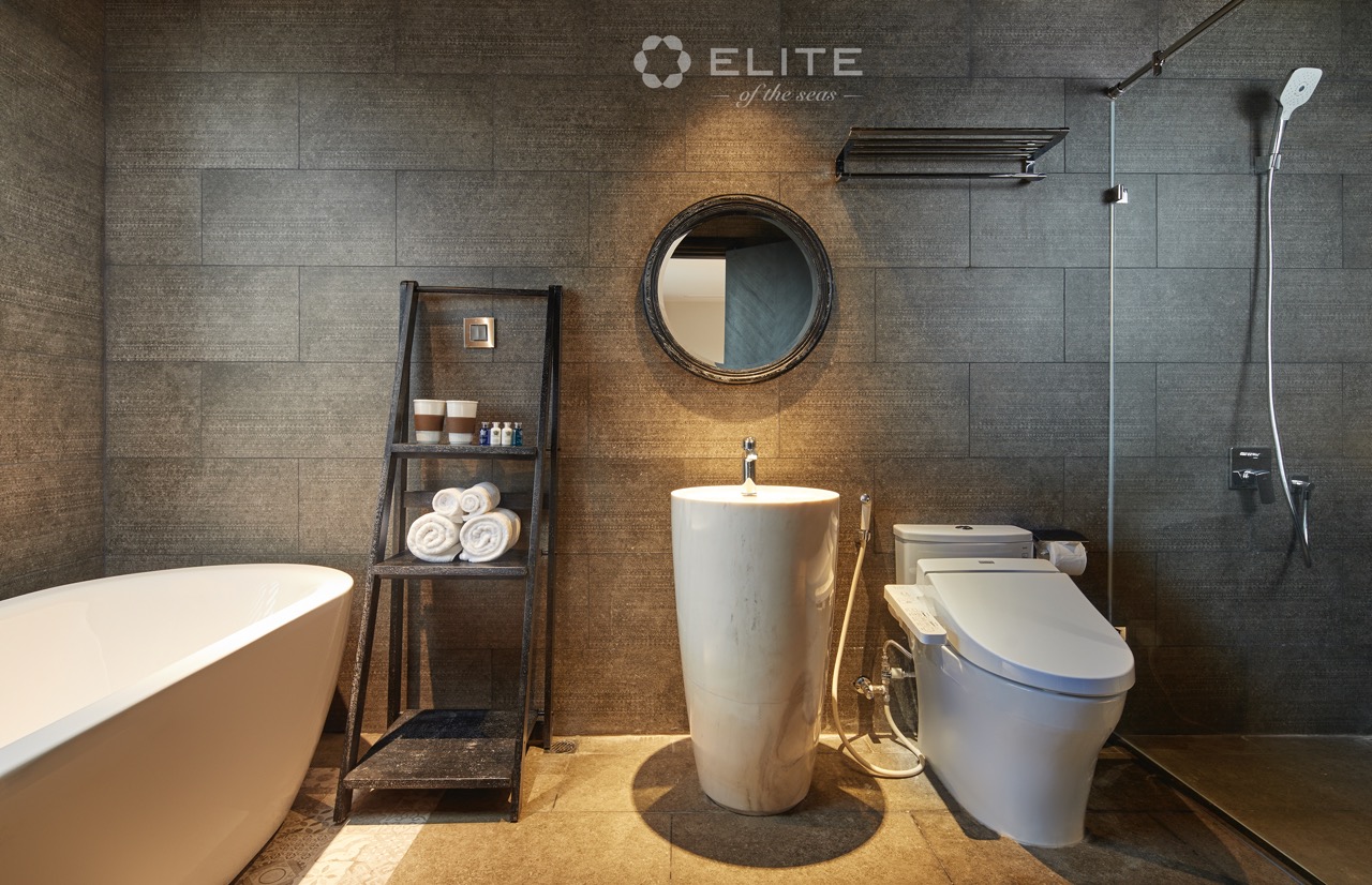 Modern bathroom with bathtub and toilet on Halong Bay cruise, luxury travel experience.