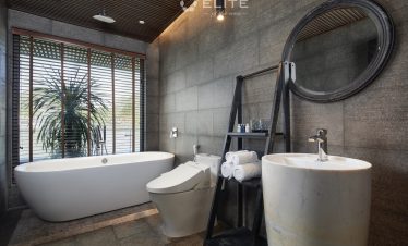 Luxurious cruise bathroom with modern amenities and scenic view of Halong Bay.