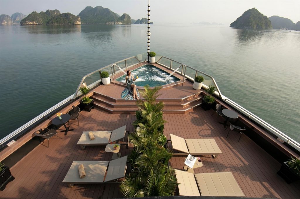 Stunning view from cruise balcony in Halong Bay with relaxing hot tub and scenic islands.