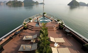 Stunning view from cruise balcony in Halong Bay with relaxing hot tub and scenic islands.