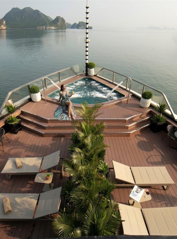 Stunning view from cruise balcony in Halong Bay with relaxing hot tub and scenic islands.