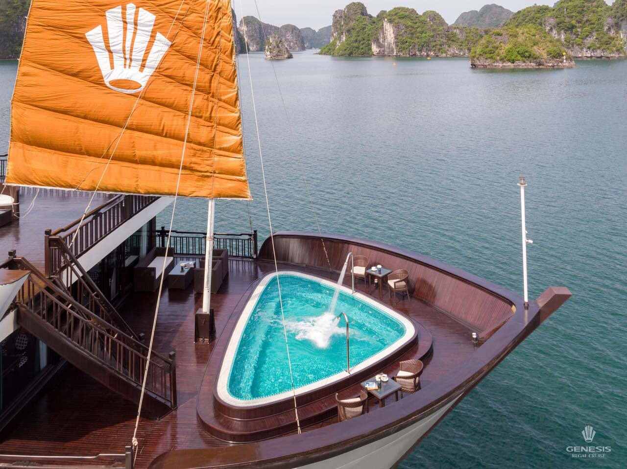 Stunning view of Halong Bay from a cruise balcony, showcasing limestone karsts and tranquil waters,.