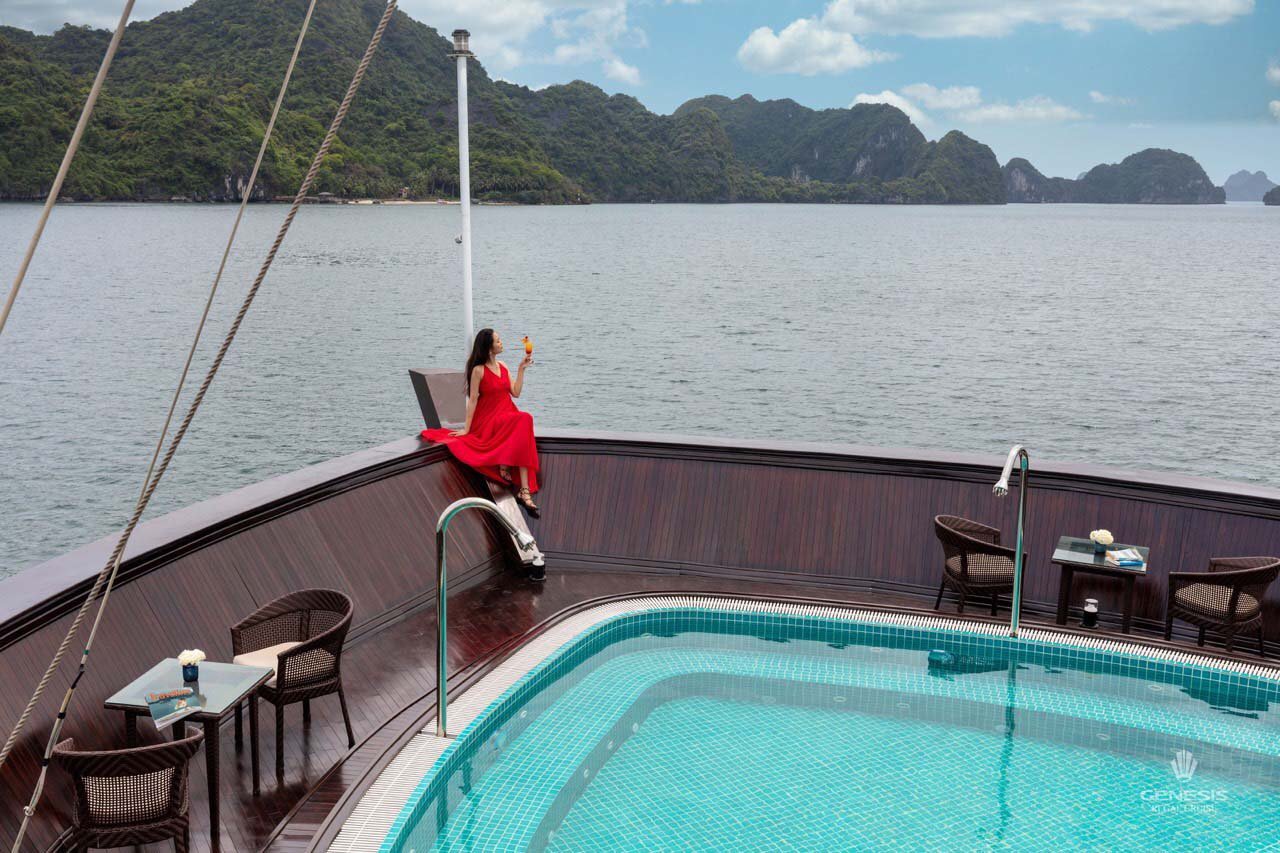 Stunning view of Halong Bay from a cruise balcony with a woman enjoying the scenery and relaxing atm.