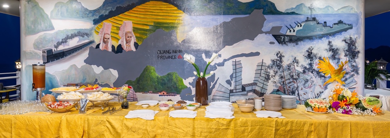 Beautiful cruise buffet table with scenic Halong Bay backdrop, perfect for a relaxing day on the wat.
