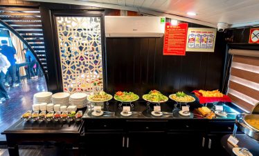 Stunning Halong Bay cruise balcony with scenic views and luxurious dining experience.
