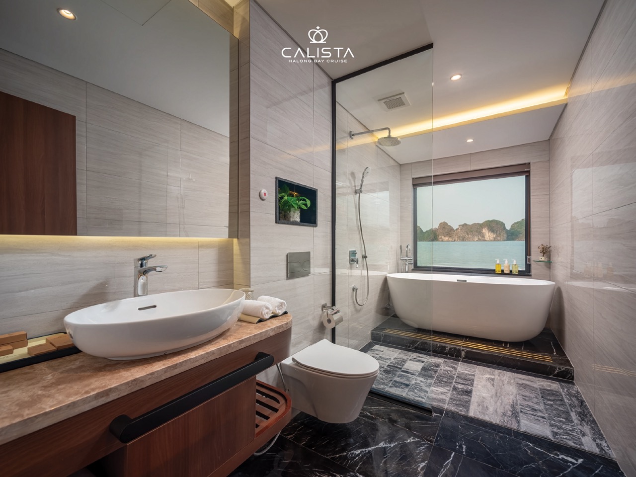 Luxurious bathroom with bathtub and scenic view in Halong Bay cruise.
