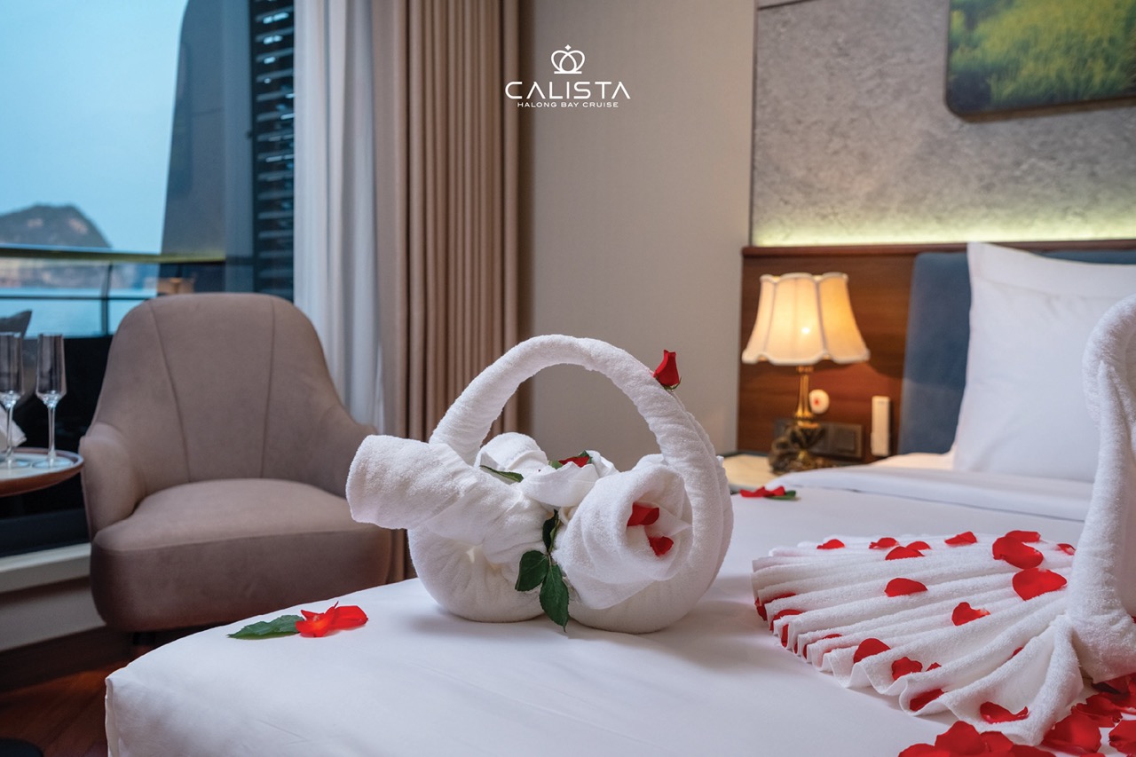 Beautiful cruise balcony view of Halong Bay with romantic rose petal decor.