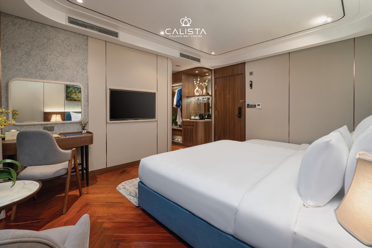Elegant cruise balcony view in Halong Bay showcasing a luxurious bedroom scene.