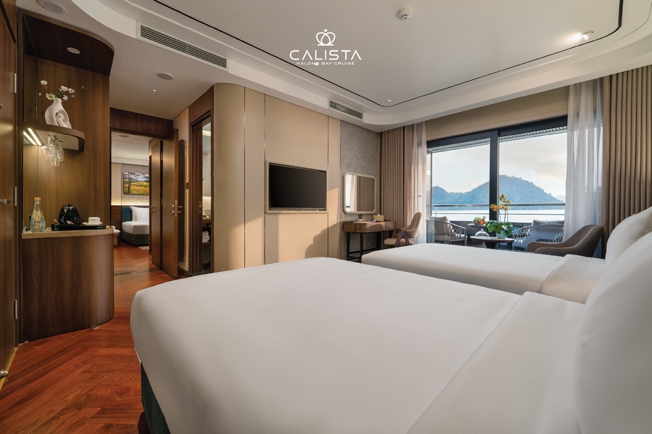 Stunning view from the cruise balcony overlooking Halong Bay's emerald waters and limestone karsts.