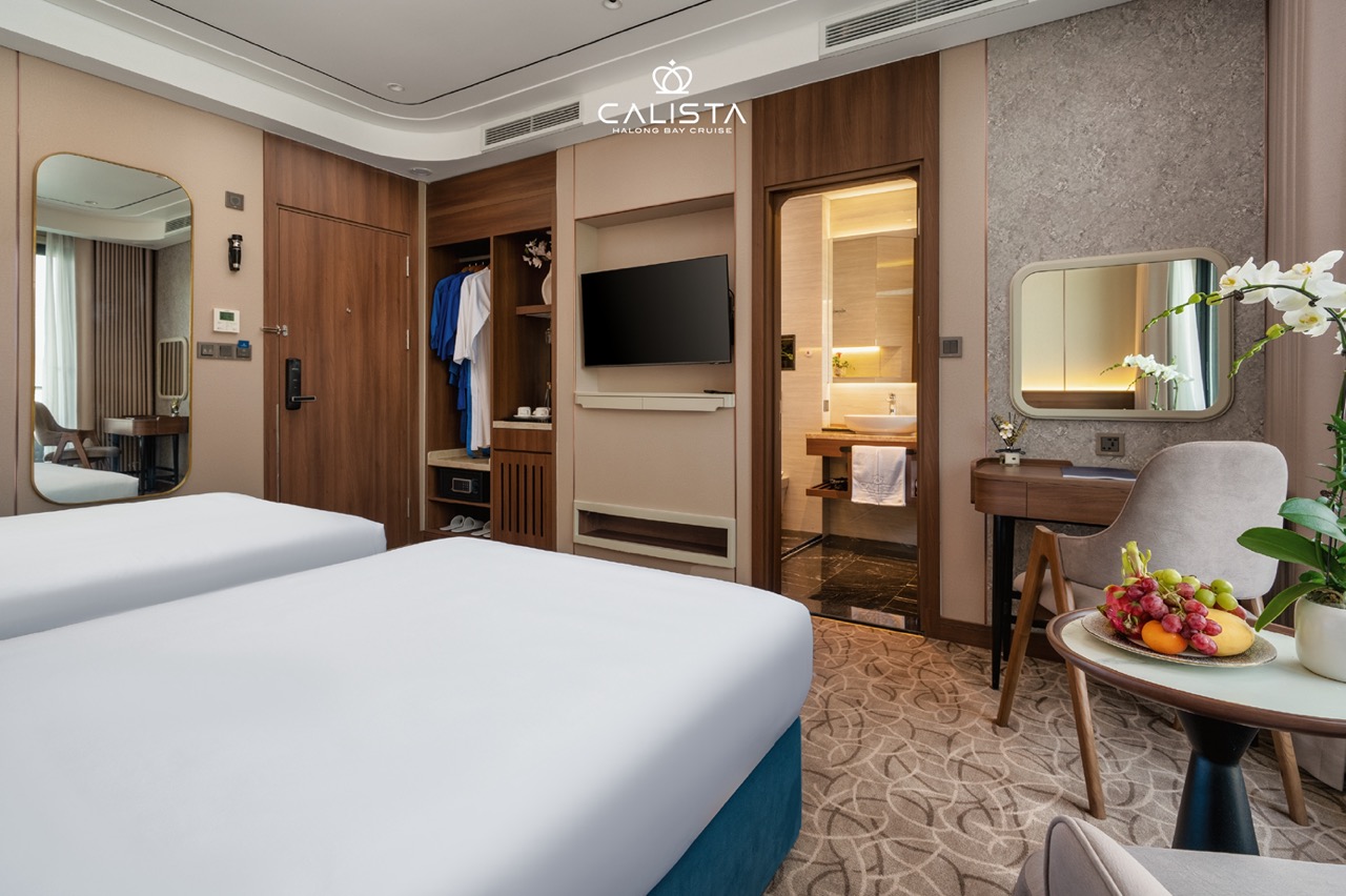 Spacious cruise room with modern amenities and elegant decor, perfect for a relaxing Halong Bay 2D1N.
