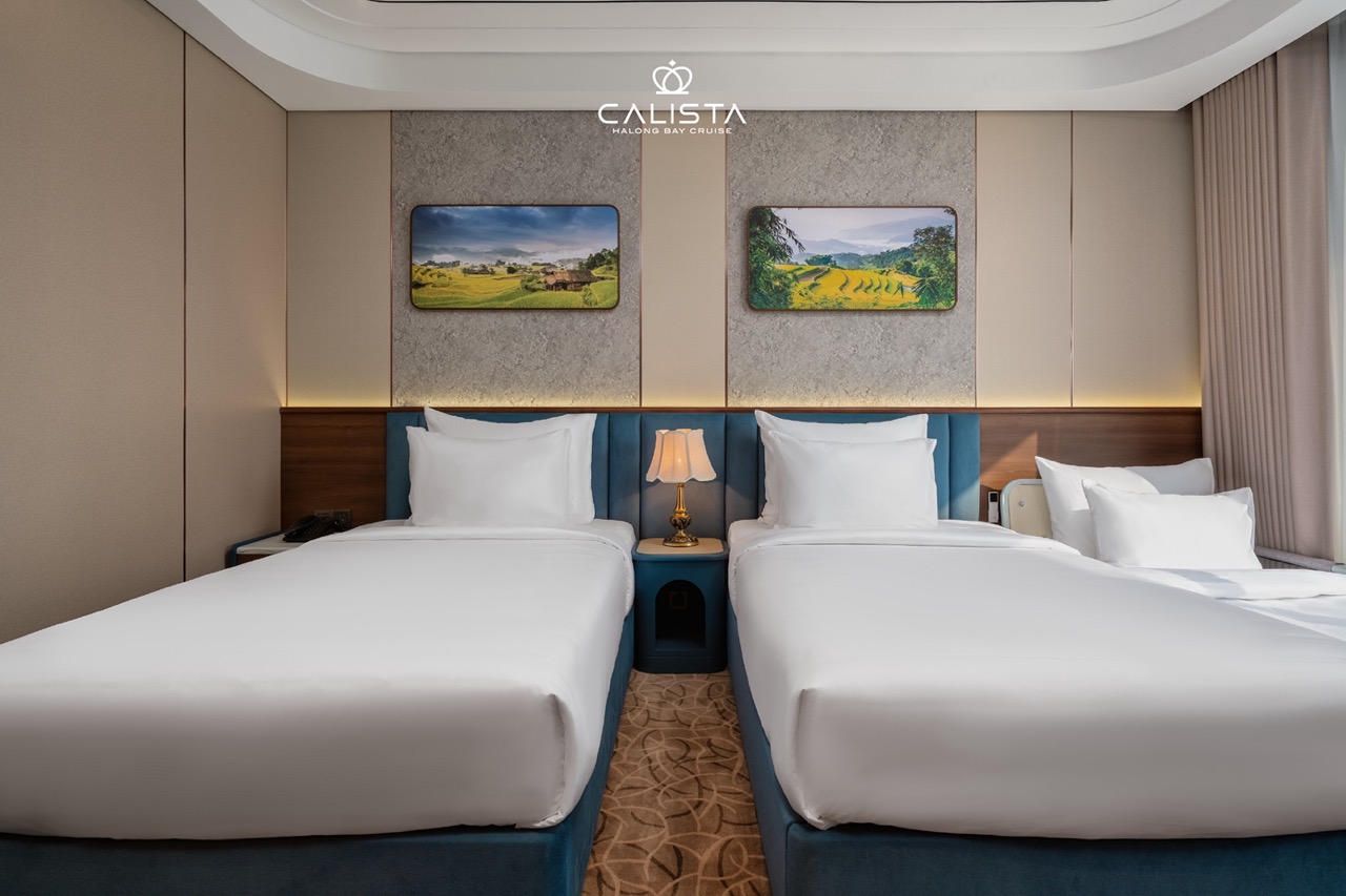 Luxurious Halong Bay cruise cabin with cozy beds and scenic views, perfect for a 2D1N ViettrendTour.