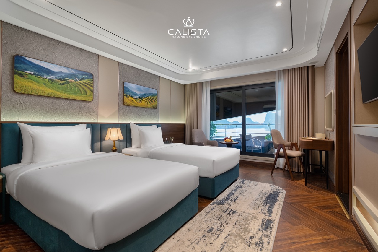Elegant cruise balcony view of Halong Bay with serene waters and towering limestone karsts.